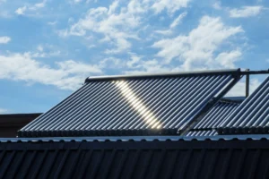 Solar pool heating panels installed on a residential roof under a sunny sky