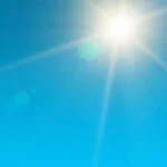 Bright sun shining in a clear blue sky
