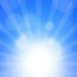 Bright sun shining in a clear blue sky